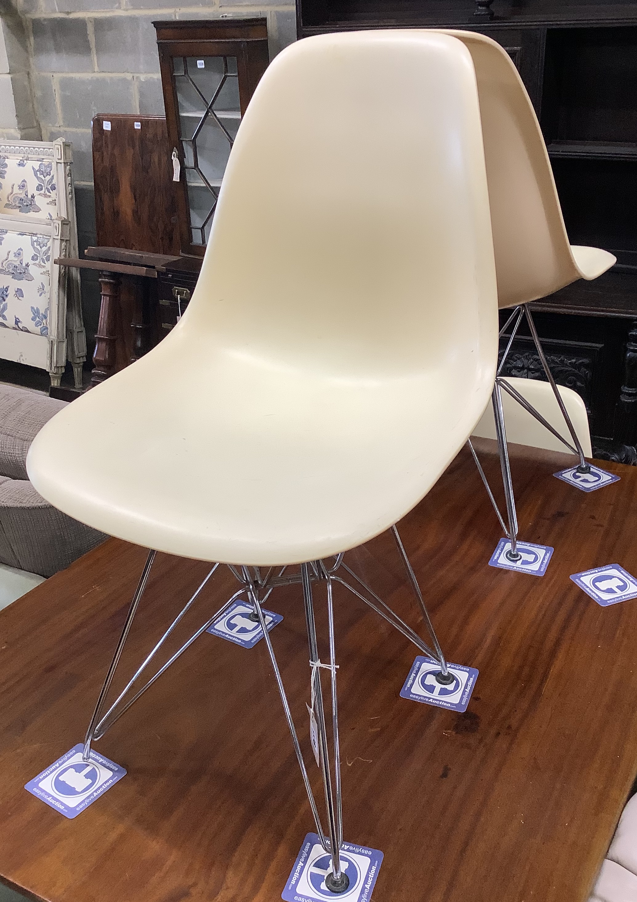 A set of four Eames fibre glass Eifel base chairs
